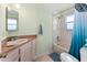 Cozy bathroom features a shower over bath and a vanity with sink and storage at 333 Stanley Bell Dr, Mount Dora, FL 32757