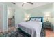 Bedroom with ensuite Bathroom featuring a Queen bed, lamps on side tables, and a ceiling fan at 333 Stanley Bell Dr, Mount Dora, FL 32757