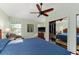 Bedroom with ceiling fan, closet, mirror, and natural light from windows with coverings at 333 Stanley Bell Dr, Mount Dora, FL 32757