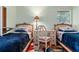 Bedroom featuring matching twin beds separated by a desk and chair at 333 Stanley Bell Dr, Mount Dora, FL 32757