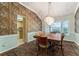 Dining room features distinctive peacock wallpaper and leads to the adjacent kitchen at 333 Stanley Bell Dr, Mount Dora, FL 32757