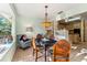 Bright dining area with tile flooring, a black table, and natural lighting from a window at 333 Stanley Bell Dr, Mount Dora, FL 32757