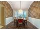 Formal dining room featuring elegant wallpaper, a chandelier, and a bay window with views of the outdoors at 333 Stanley Bell Dr, Mount Dora, FL 32757