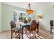 Dining room features a table and chairs with a window and decorative lamp at 333 Stanley Bell Dr, Mount Dora, FL 32757