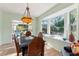 Bright dining room featuring a bay window with backyard views and an ornate hanging light fixture at 333 Stanley Bell Dr, Mount Dora, FL 32757
