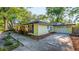 Bright yellow house featuring black shutters and a concrete driveway leading to an attached garage at 333 Stanley Bell Dr, Mount Dora, FL 32757