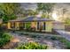 Charming, yellow one-story home featuring a green front door, manicured landscaping, and an attached two-car garage at 333 Stanley Bell Dr, Mount Dora, FL 32757