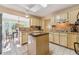 Functional kitchen with an island, neutral countertops, ample cabinet space, and a view into the breakfast nook at 333 Stanley Bell Dr, Mount Dora, FL 32757