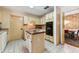 Functional kitchen with an island, tile flooring, and access to the formal dining room at 333 Stanley Bell Dr, Mount Dora, FL 32757