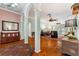 Bright, open living room showcasing hardwood floors, large columns, multiple ceiling fans, and doors to an outdoor patio at 333 Stanley Bell Dr, Mount Dora, FL 32757