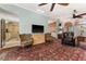 Spacious living room with tile flooring, multiple ceiling fans, and vintage patterned furnishings at 333 Stanley Bell Dr, Mount Dora, FL 32757