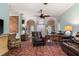 Inviting living room with archways, a ceiling fan, vintage furnishings, and a unique area rug at 333 Stanley Bell Dr, Mount Dora, FL 32757