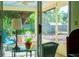 Serene view from inside the screened patio, showcasing outdoor seating and lush backyard landscaping at 333 Stanley Bell Dr, Mount Dora, FL 32757