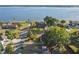 Aerial view showcasing a waterfront property with lush landscaping, mature trees, and access to the lake at 33801 Picciola Dr, Fruitland Park, FL 34731