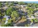 A sprawling aerial view of a neighborhood showcasing the home's proximity to lush greenery and waterfront at 33801 Picciola Dr, Fruitland Park, FL 34731