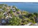 Expansive aerial view showcasing the waterfront property's prime location near a beautiful lake at 33801 Picciola Dr, Fruitland Park, FL 34731