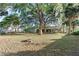 Expansive backyard showcasing mature trees, lush green grass, and a peaceful setting at 33801 Picciola Dr, Fruitland Park, FL 34731