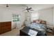 Cozy bedroom featuring a ceiling fan, natural light from the windows, and a comfortable wicker bed at 33801 Picciola Dr, Fruitland Park, FL 34731