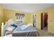 Comfortable bedroom with yellow walls, two windows, and closet storage, adjacent to an attached bathroom at 33801 Picciola Dr, Fruitland Park, FL 34731