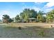Charming single-story home with mature trees, a spacious front yard, and welcoming curb appeal at 33801 Picciola Dr, Fruitland Park, FL 34731