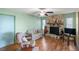 Living room with stone fireplace, wood floors, ceiling fan, and comfortable seating at 33801 Picciola Dr, Fruitland Park, FL 34731