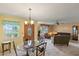 Bright living room with dining area, front door, neutral walls, and view of the outside at 33801 Picciola Dr, Fruitland Park, FL 34731