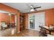 Bright home office featuring hardwood flooring, desk, chair and view to outside at 33801 Picciola Dr, Fruitland Park, FL 34731