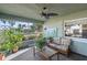 A refreshing sunroom with tropical plants, a ceiling fan, and views to a water view at 33801 Picciola Dr, Fruitland Park, FL 34731