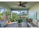 Enclosed sunroom featuring views of the water, tropical plants, and seating for relaxing and enjoying scenery at 33801 Picciola Dr, Fruitland Park, FL 34731