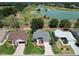 Aerial shot of a lovely neighborhood adjacent to a golf course and lake at 3614 Auburndale Ave, The Villages, FL 32162