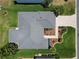 An aerial view showcases this home's roof, landscaping, and paver driveway at 3614 Auburndale Ave, The Villages, FL 32162