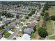 Expansive aerial view of a quiet neighborhood with tree-lined streets and well-maintained lawns adjacent to a golf course at 3614 Auburndale Ave, The Villages, FL 32162