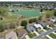 Panoramic aerial view of homes near a scenic lake and golf course at 3614 Auburndale Ave, The Villages, FL 32162