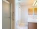Bright bathroom with a glass shower, vanity, and white tile flooring at 3614 Auburndale Ave, The Villages, FL 32162