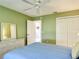 Cozy bedroom featuring a ceiling fan, closet, and dresser at 3614 Auburndale Ave, The Villages, FL 32162