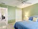 Inviting bedroom with a ceiling fan, closet, and view into an adjacent living area at 3614 Auburndale Ave, The Villages, FL 32162