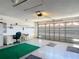 Spacious garage with an automatic door opener and a desk area at 3614 Auburndale Ave, The Villages, FL 32162