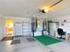 Spacious garage with painted floor, storage, and water heater system at 3614 Auburndale Ave, The Villages, FL 32162