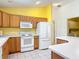 Bright and spacious kitchen featuring a full-size fridge and modern appliances at 3614 Auburndale Ave, The Villages, FL 32162