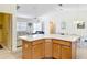 Open-concept kitchen and living area with large kitchen island at 3614 Auburndale Ave, The Villages, FL 32162