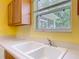 Sunny kitchen with window view of enclosed porch at 3614 Auburndale Ave, The Villages, FL 32162