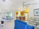 Bright living room with an open floor plan connected to the dining area and kitchen at 3614 Auburndale Ave, The Villages, FL 32162