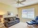 Cozy living room featuring neutral colored walls, comfortable seating, and a ceiling fan at 3614 Auburndale Ave, The Villages, FL 32162