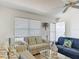 Living room featuring striped sofas, modern decor and a view to the outside at 3614 Auburndale Ave, The Villages, FL 32162