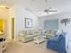 Bright living room with striped sofas and a view out the window at 3614 Auburndale Ave, The Villages, FL 32162
