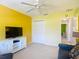 Cozy living room featuring neutral colored walls, comfortable seating, and a ceiling fan at 3614 Auburndale Ave, The Villages, FL 32162