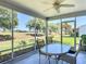 Enjoy this screened patio with beautiful green views and ceiling fan at 3614 Auburndale Ave, The Villages, FL 32162