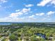 Aerial view of the property, surrounded by lush greenery and serene lakes at 3630 Oak St, Mount Dora, FL 32757
