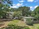 Aerial view of the property showcasing the house, large yard, and mature trees at 3630 Oak St, Mount Dora, FL 32757