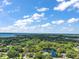 Breathtaking aerial view showcasing a vast landscape with a pond, framed by mature trees and distant lake views at 3630 Oak St, Mount Dora, FL 32757